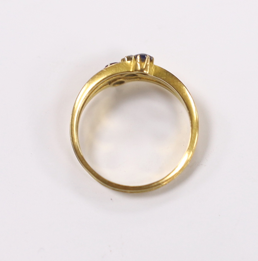 A late Victorian 18ct gold, sapphire ruby and diamond set three stone triple shank ring, size N, gross weight 2.9 grams.